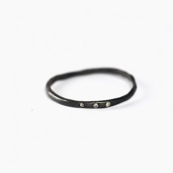 Thin black silver ring with three artificial diamonds
